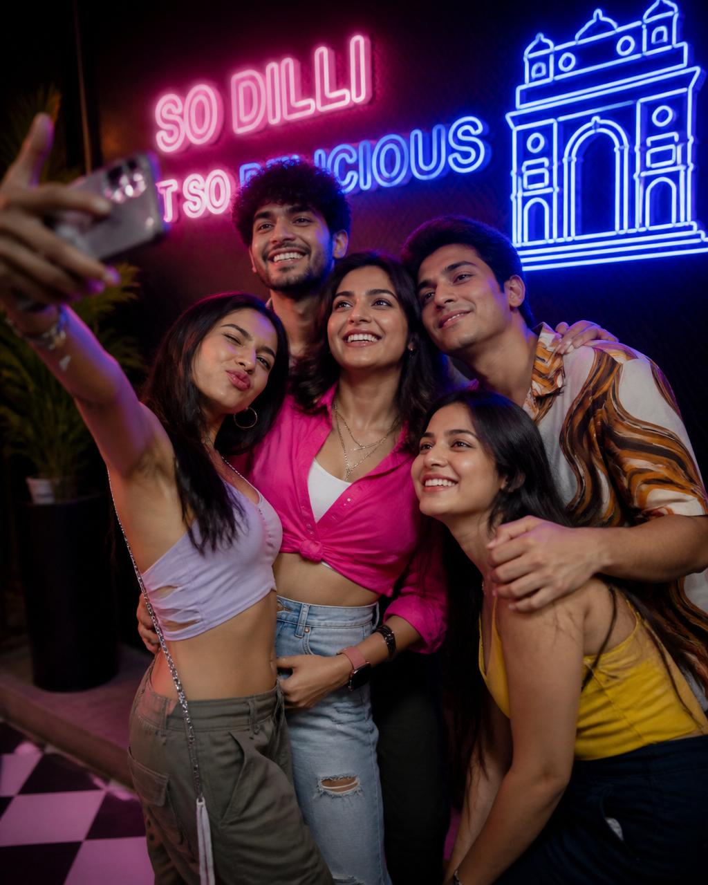 Friends at a neon selfie wall